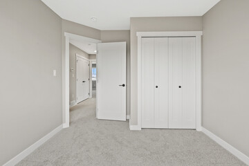 White room with a door leading to a hallway