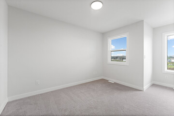 White room with a window and a light fixture