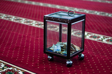 Charity box in the mosque containing donation money