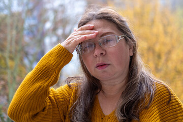 50-year-old woman experiencing hot flashes due to menopause and high blood pressure, high blood...