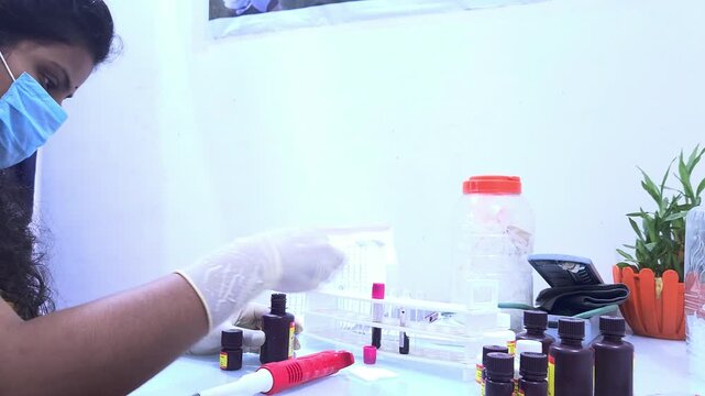 Indian pathologist working in laboratory