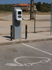Charging station for electric cars and parking space