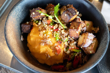 Stir-fried black tofu with chili, salt, garlic and pepper with Thai-style scrambled eggs. Authentic the rare black tofu found only in Ratchaburi, Photharam Village, Thailand.