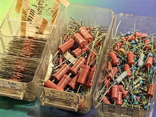 A collection of electronic components neatly organized in labeled bins, ready for use or repair.