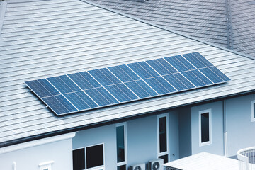 Obraz premium Solar roof top, Solar panel installed at modern house roof for saving home energy electricity cost.