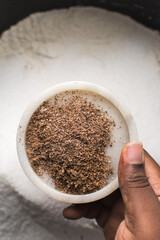 Overhead view of freshly grated Nutmeg in a marble tray
