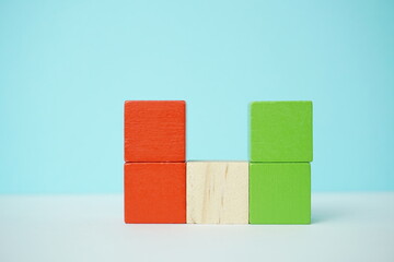 Colorful wooden blocks arranged against a bright background for concept representation