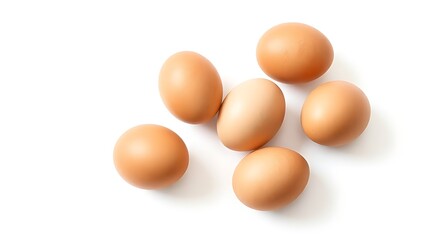 Brown eggs on a white surface, showcasing natural texture and subtle shadows in a minimalist composition.