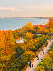 People are walking in an autumn park near the Baltic Sea. Gdansk