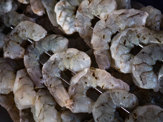 Fresh shrimp skewers prepared for grilling