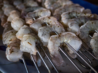 Fresh shrimp skewers prepared for grilling