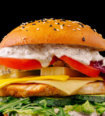 Tasty chicken sandwich on a sesame bun with fresh ingredients