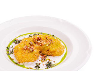 Deliciously plated gourmet dish featuring crispy fried elements and garnish