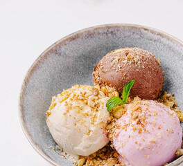 Delightful selection of ice cream scoops in a stylish bowl with toppings
