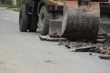 Tractor operated ditch digging for drainage concrete sewage a pipe installation, Pakistan 14-August-2025, Aerial view of scoop excavators in action on a construction site, showing progress