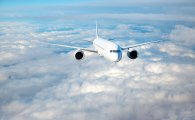 White passenger airplane flying in the sky amazing clouds in the background - Travel by air...