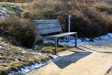 An empty bench in a public park in Warsaw, Poland