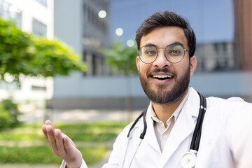 A cheerful doctor outdoors, wearing a white coat and stethoscope, showcasing positivity and...