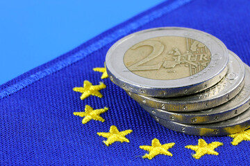 The flag of Europe and an angled stack of two-euro coins