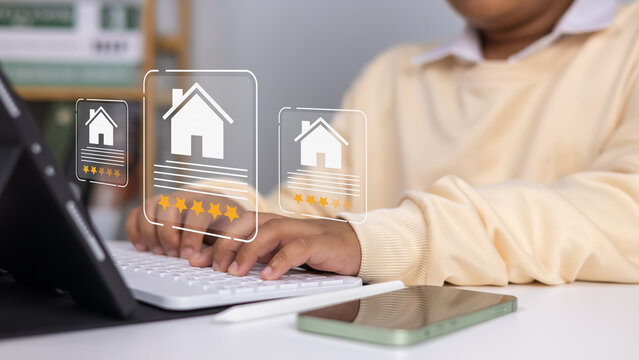 Real estate review rating concept showing businessman using digital pen on laptop to give property five-star rating, smart technology, online service, feedback system, home buying, housing evaluation.