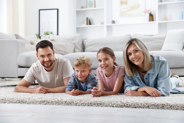 Happy family posing on floor at home
