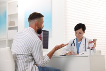 Fototapeta premium Man having appointment with gastroenterologist in clinic