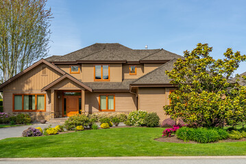 Two story stucco luxury house with nice spring blossom landscape in Vancouver, Canada, North...