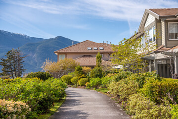 Two story stucco luxury house with nice spring blossom landscape in Vancouver, Canada, North...