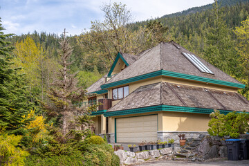 Two story stucco luxury house with nice spring blossom landscape in Vancouver, Canada, North...