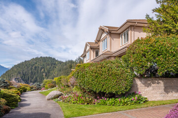 Two story stucco luxury house with nice spring blossom landscape in Vancouver, Canada, North...