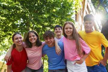 Portrait of happy teenage friends together outdoors. low angle view