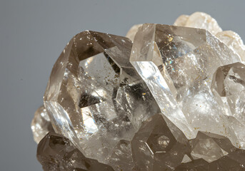 Close-up of a cluster of translucent, light brown quartz crystals with visible facets and internal structures.