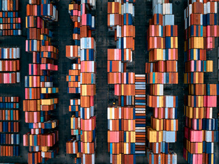 warehouses, containers goods stacked, lined up to wait for distribution to consumers and dealers by ship and truck transportation, industrial, transportation and financial business concept, © SHUTTER DIN