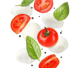 Mozzarella cheese, tomato pieces and basil leaves falling against white background