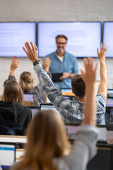 A teacher hosting a virtual lecture with slides, engaging students remotely while checking raised hands online.
