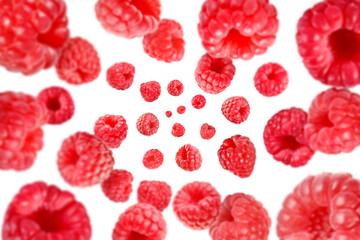 Fresh raspberries swirling in air against white background