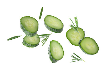 Cucumber slices and rosemary flying against white background