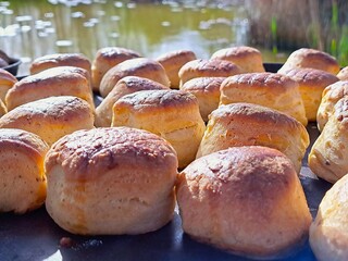 A table set next to the garden pond with freshly baked scones, photographed up close.