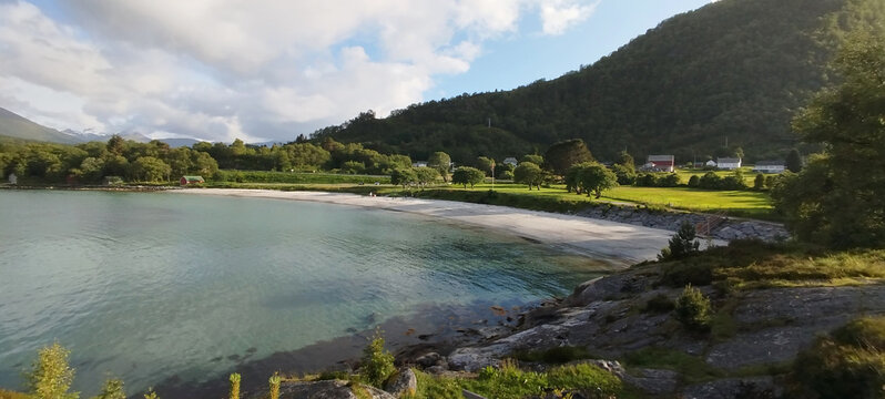 Stunning white sand beach in Hareid island, Norway. White beach below majestic mountains in Sunnmore.