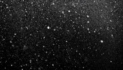 Obraz premium abstract grayscale texture with scattered white speckles on black background