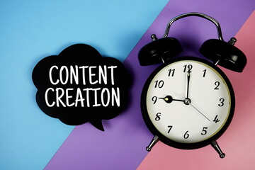 Content Creation text on speech bubble with alarm clock top view on  blue, purple and pink...