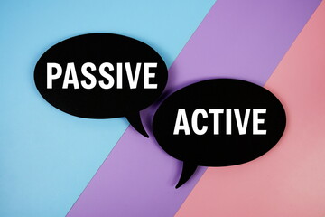 Passive vs Active text on speech bubble top view on blue, purple and pink geometric background