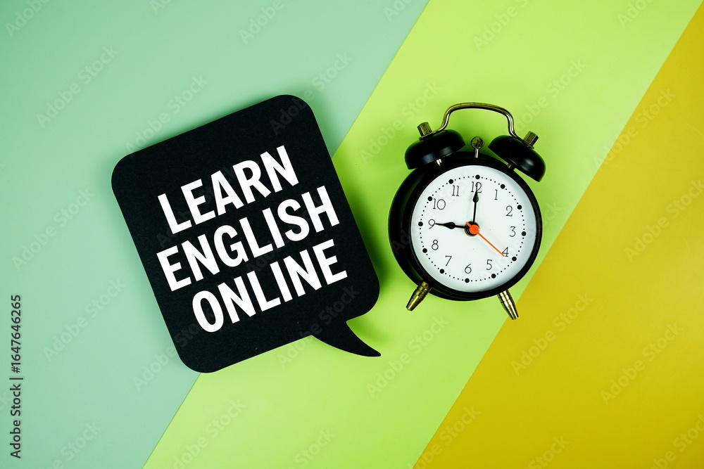 Poster learn english online text on speech bubble with alarm clock top view on green and yellow geometric b
