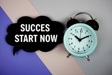Success Start Now text on speech bubble top view on purple geometric background