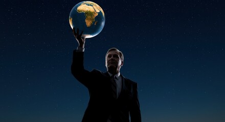 A man holds a glowing globe against a starry night sky dressed in a suit