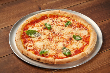 Delicious pizza margherita resting on wooden table