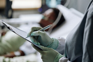 Selective focus close-up of unrecognizable doctor wearing latex gloves checking patient making...