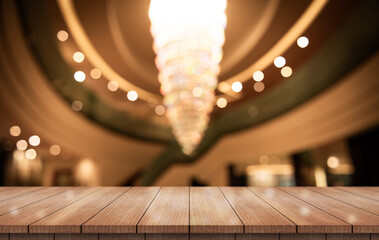 Empty wooden table top with lights bokeh on blur restaurant background.