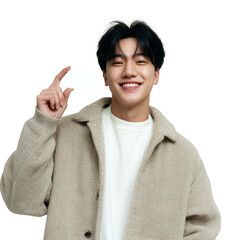 A young man is smiling and holding up a white card