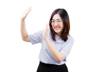 A smiling Asian young beautiful woman in a casual outfit gestures playfully with her hands, exuding a cheerful and friendly vibe.